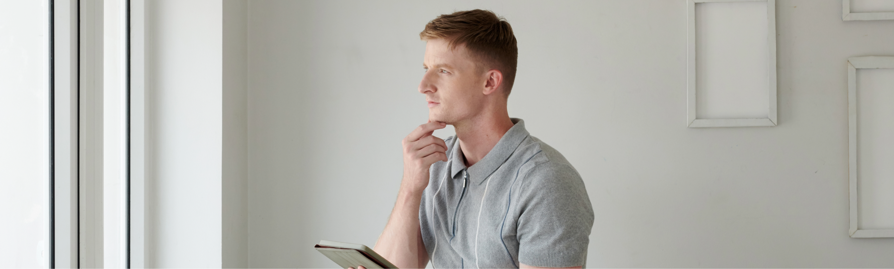 Photo of a man with his hand on his chin pondering 